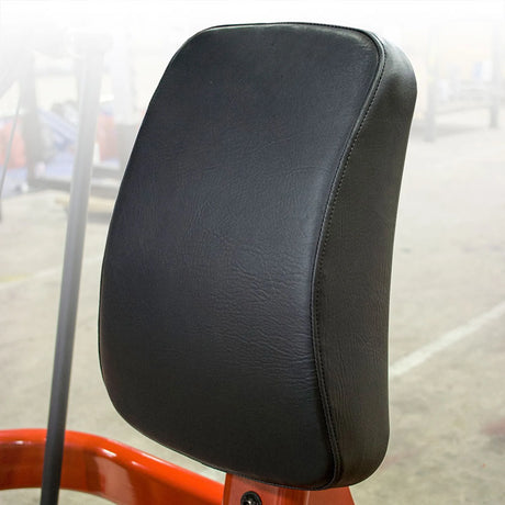 Closeup of a black pad on a red framed fitness machine.