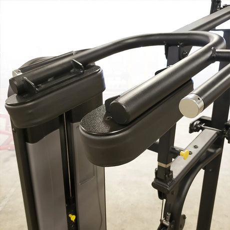 Closeup of a black frame with black pads of a gym machine on a white background