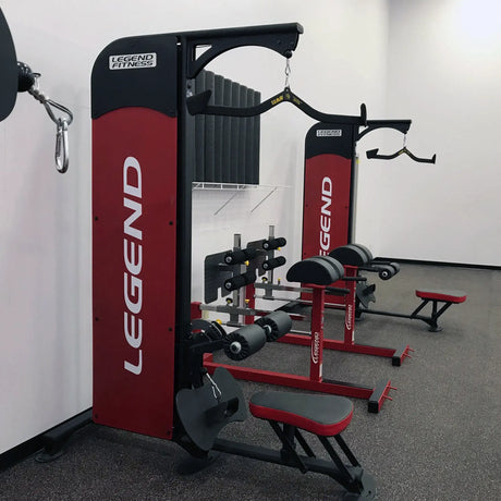 Red and black Legend Fitness gym equipment in a room.