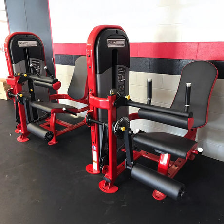Red and black weightlifting machines in a gym setting