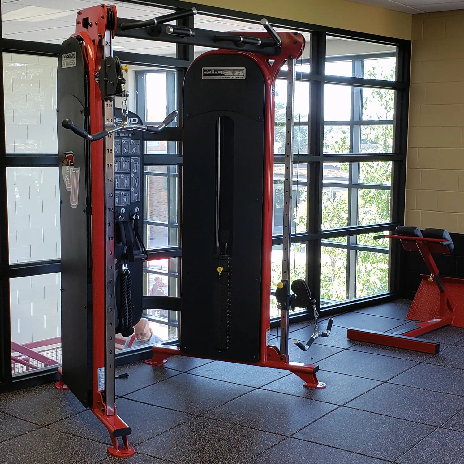 Gym equipment in a room with large windows