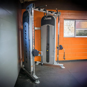 Gym machine with 'Legend' branding against an orange wall.
