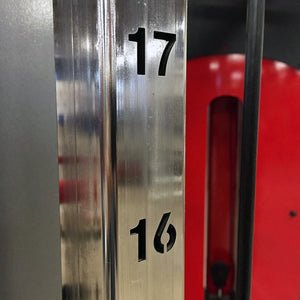 Closeup image of a vertical metal beam with the numbers 17 and 16 cut into the side of the beam