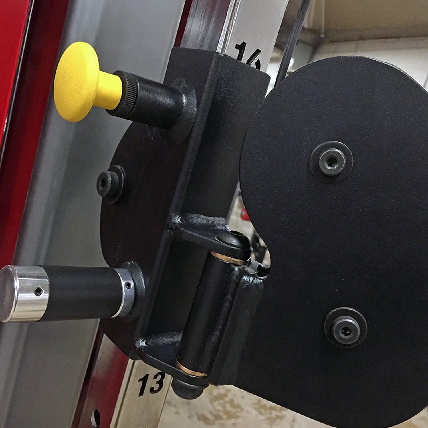 Closeup image of a black pulley with a yellow pop-pin
