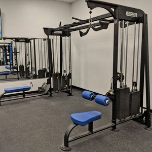 Gym equipment with blue padding in a fitness center