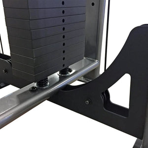 Closeup of a black weight stack on a piece of gym equipment with awhite background