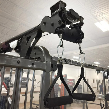 Two black nylon D grip handles hanging from a piece of gym equipment