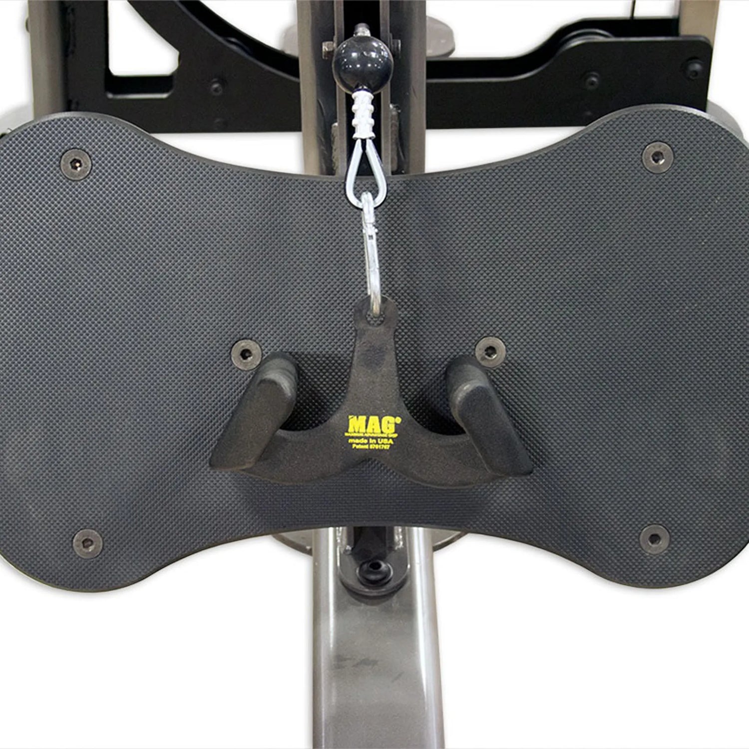 Black UHMW footplate on a gym machine with a MAG brand handleleaning against it