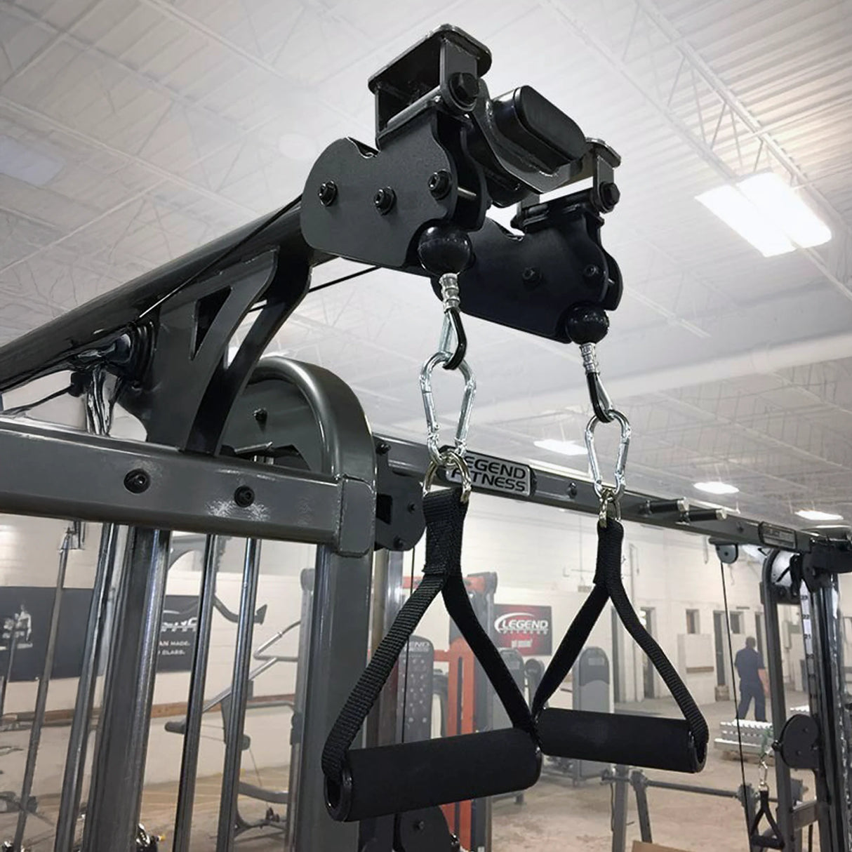Gym equipment with black handle attachments in a gym setting