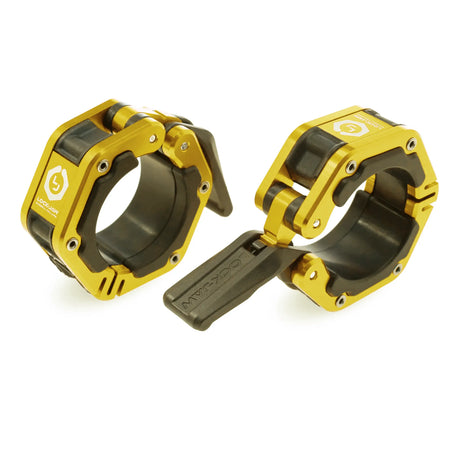 A pair of black and gold Lock-Jaw metal barbell collars with visible branding and magnets on the inside.