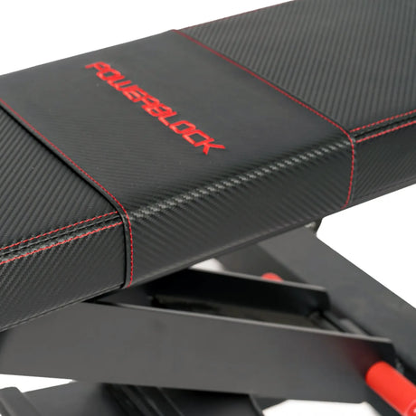 A closeup image of the back pad on a black PowerBlock utility bench
