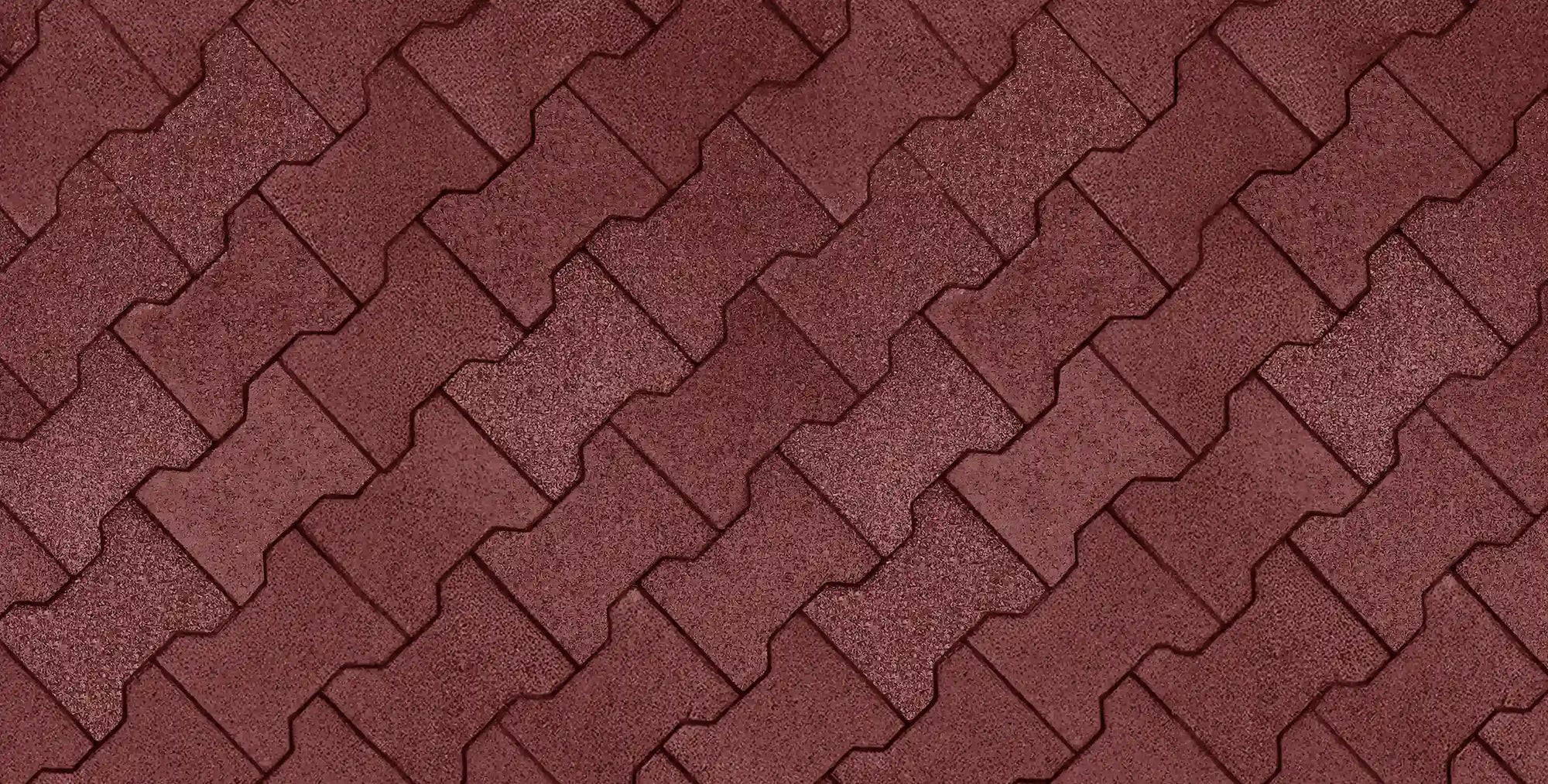 An overhead top-down view of a floor made from red rubber pavers in an interlocking pattern