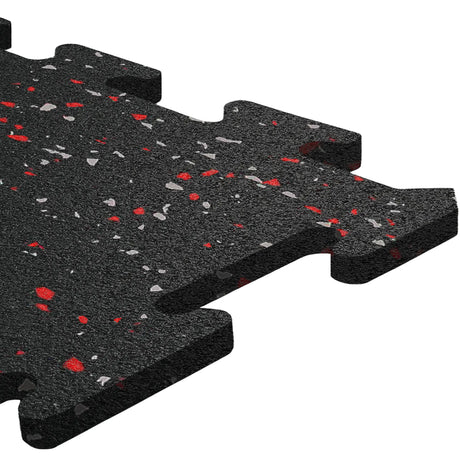 A close-up of ECORE Athletic's ECORE Rubber Floor Tiles - 8mm Interlocking, black with red and gray speckles, showcases the textured surface and puzzle-like edges for easy assembly.