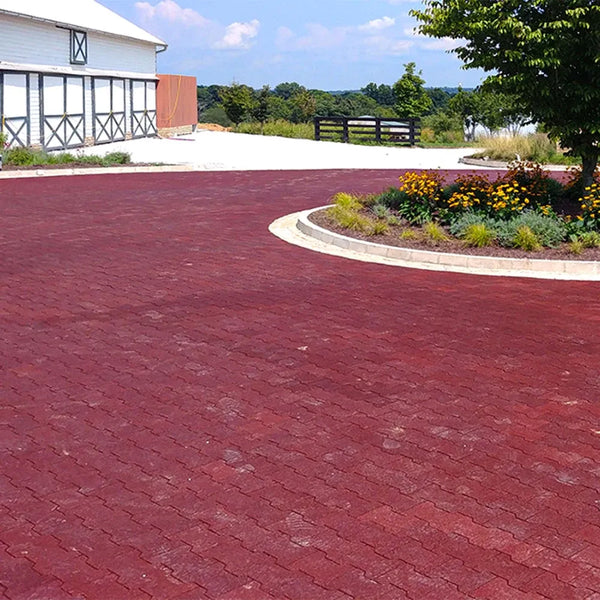 Red rubber paver turnaround with a large garage in the background