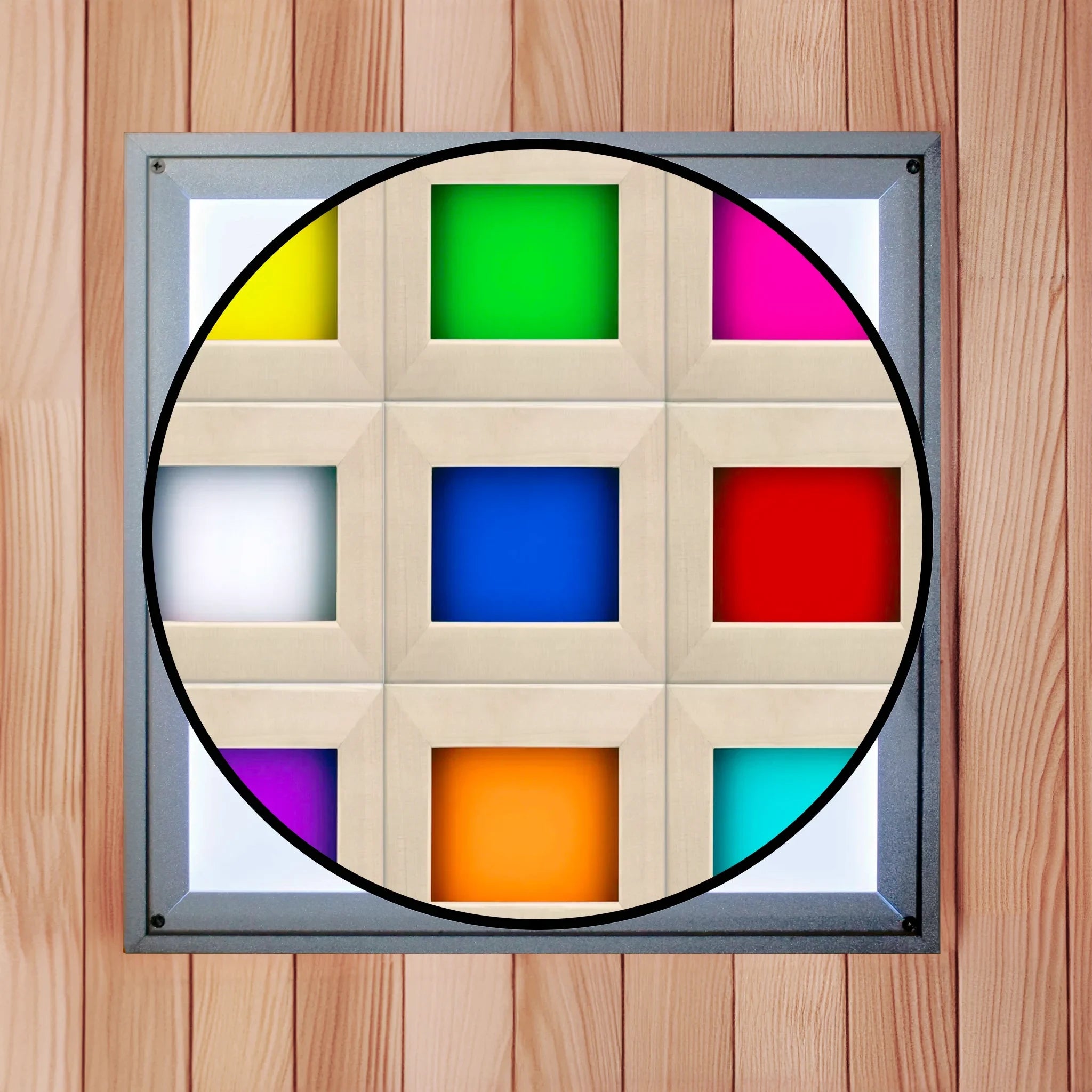 White overhead chromotherapy light found inside of a sauna with a cutout illustrating the 9 colors the light can generate. The colors include yellow, green, magenta, white, royal blue, red, aqua, orange, and purple