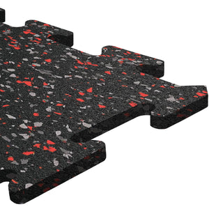 Close-up of an ECORE Athletic ECORE Rubber Floor Tiles - 8mm Interlocking tile in black with red and gray speckles, featuring puzzle-like edges for easy assembly—ideal for gyms or play areas—shown on a white background.