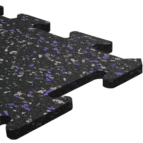A close-up of the ECORE Athletic ECORE Rubber Floor Tiles - 8mm Interlocking, featuring black tiles with gray and purple speckles and puzzle-like edges.