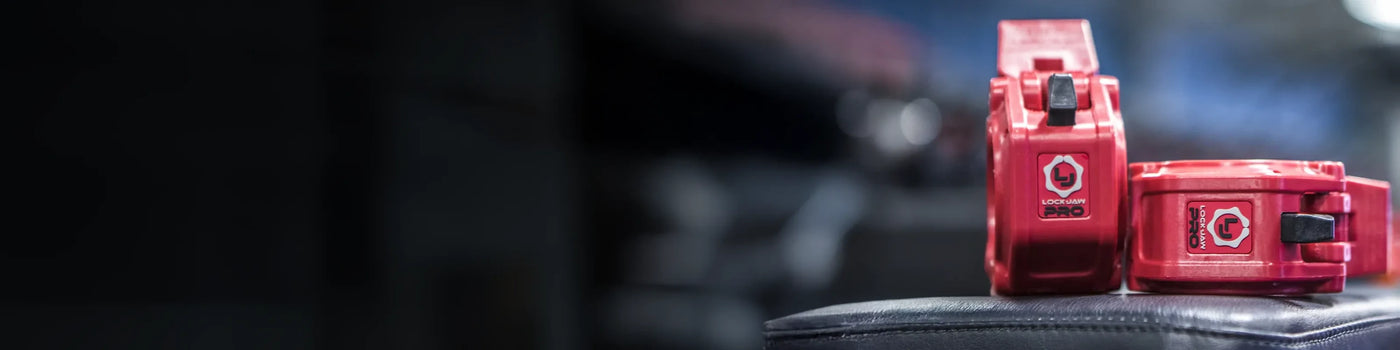 Lock-Jaw barbell collars sitting on gym bench