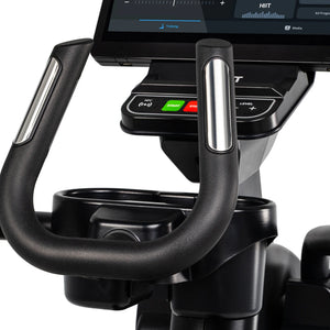 Extreme close-up of the Spirit Fitness CE1000ENT Elliptical handlebar grips and control panel shows the NFC reader, green Start and red Stop buttons, Level adjustment buttons, and integrated cup holder. Brand: Spirit Fitness.