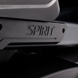 Macro close-up of the Spirit logo badge on the shroud of the Spirit Fitness CE1000ENT Elliptical.