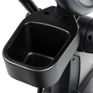 Close-up of the Spirit Fitness CE800 Elliptical's black plastic cup holder by Spirit Fitness, featuring a deep, square-shaped interior and sturdy construction attached to the gym equipment.