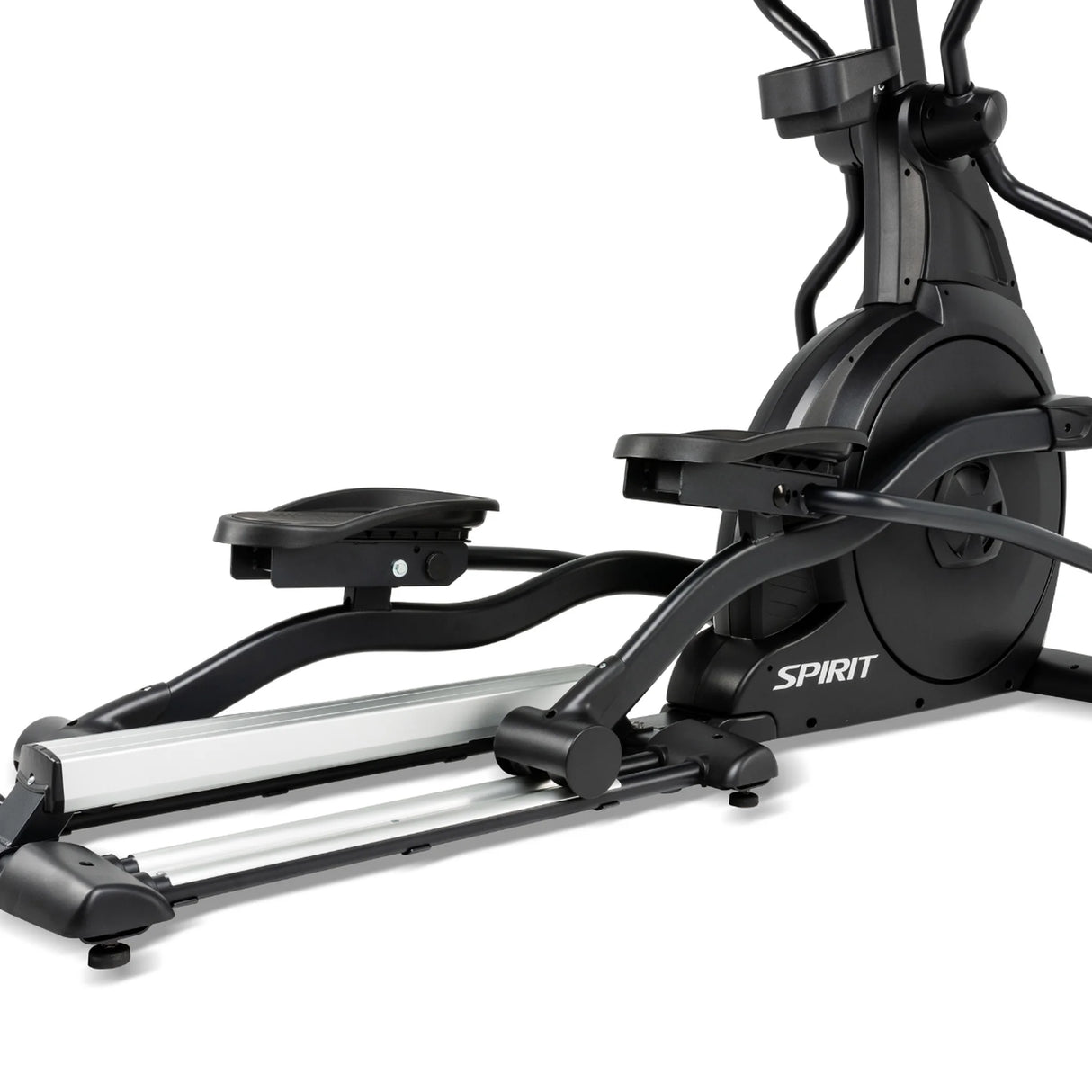 A close-up of the Spirit Fitness CE800 Elliptical highlights its black pedals, sturdy base, and flywheel, with the Spirit Fitness brand name visible on the side.