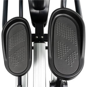 Close-up view of two textured black foot pedals on the Spirit Fitness CE800 Elliptical by Spirit Fitness, highlighting the patterned non-slip surfaces and a portion of the silver central frame below.