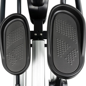 Close-up of two textured black foot pedals on the Spirit Fitness CE800ENT Elliptical by Spirit Fitness, featuring a metal bar and support structure between them.