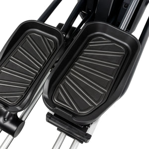 Close-up view of two black textured foot pedals on the Spirit Fitness CE850 Elliptical by Spirit Fitness, with metal rods visible underneath.