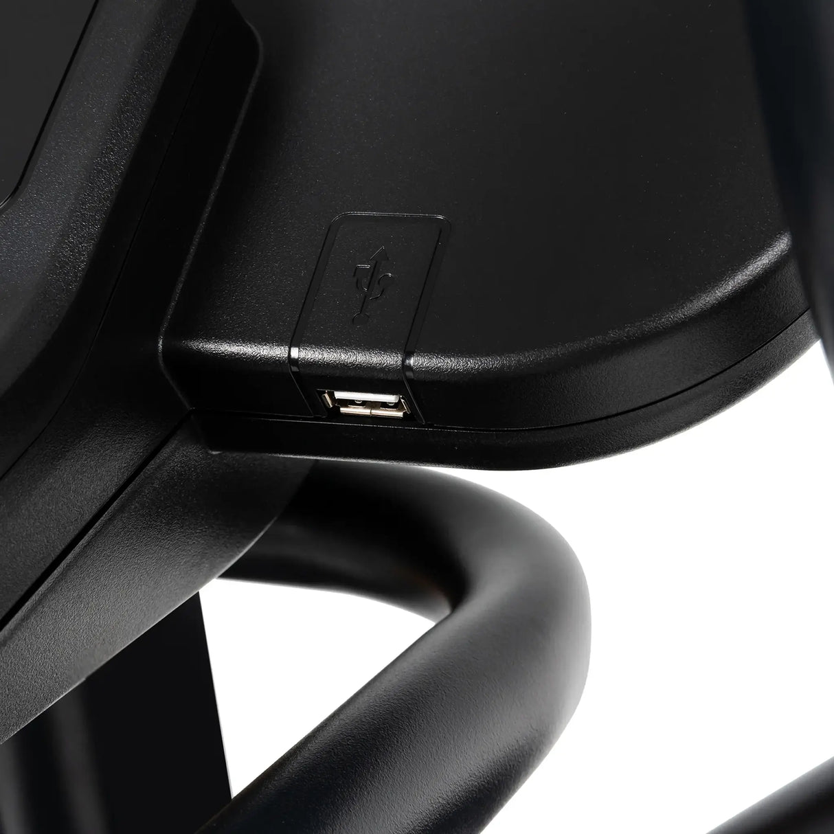 Close-up of the Spirit Fitness CE850 Elliptical by Spirit Fitness, featuring a built-in USB port for convenient device charging, with curved metal bars visible beneath its surface.