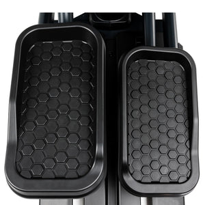The Spirit Fitness CE900 Elliptical by Spirit Fitness features black pedals with a hexagonal grip pattern.