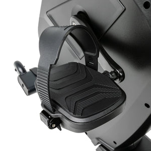 Close-up of the Spirit Fitness CR1000ENT Recumbent Bike pedal, showing the textured foot plate, adjustable strap, and crank arm attached to the black flywheel housing.