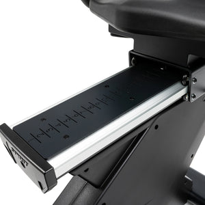 Close-up of the Spirit Fitness CR1000ENT Recumbent Bike's numbered seat rail, marked 1 through 14, allowing riders to fine-tune the seat's fore-aft position. Brand: Spirit Fitness.