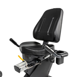 A close-up of the Spirit Fitness CR800 Recumbent Bike by Spirit Fitness, featuring a black padded seat with back support, side handlebars, an adjustment lever, and a cup holder on the frame.