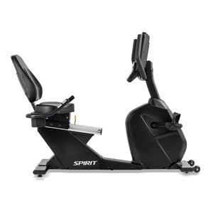 The Spirit Fitness CR800ENT Recumbent Bike by Spirit Fitness in matte black features a padded seat with backrest, adjustable console with handlebars, pedals, and transport wheels, shown in side profile on a white background.