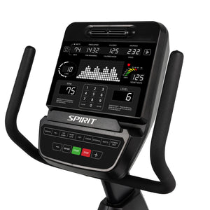 Close-up of the Spirit Fitness CR900 Recumbent Bike display by Spirit Fitness, showing workout stats like time, calories, distance, RPM, speed, level, and heart rate with control buttons and two handlebars visible.