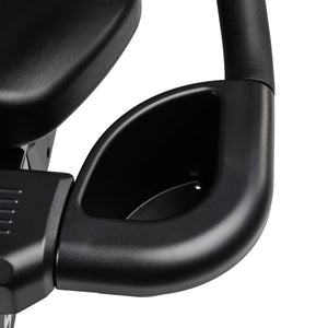Close-up of a black plastic cup holder attached to the armrest of the Spirit Fitness CR900 Recumbent Bike by Spirit Fitness, with part of the seat visible in the upper left corner.