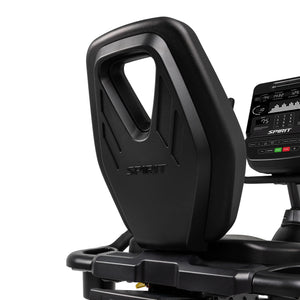 Close-up of the Spirit Fitness CR900 Recumbent Bike’s black seat with a large ergonomic backrest and “SPIRIT” embossed on it. The bike’s digital display and control panel from Spirit Fitness are partially visible.