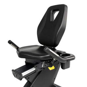 A close-up of the Spirit Fitness CR900 Recumbent Bike’s black adjustable seat with backrest, armrests, cup holder, handle, and sliding adjustment mechanism by Spirit Fitness.