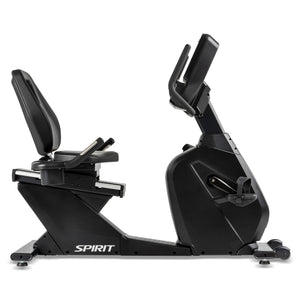 The Spirit Fitness CR900 Recumbent Bike by Spirit Fitness is shown in a side profile, featuring a black frame with cushioned seat, backrest, pedals, digital display screen, and the SPIRIT logo on the side.