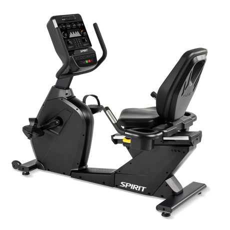 The Spirit Fitness CR900 Recumbent Bike is a black exercise bike with a digital display, padded seat with back support, pedals, and the Spirit Fitness logo on the base.