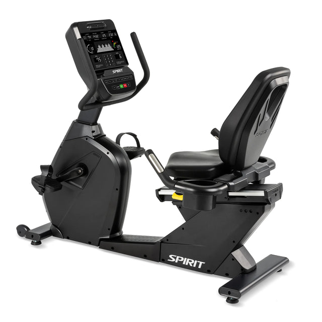 The Spirit Fitness CR900 Recumbent Bike is a black exercise bike with a digital display, padded seat with back support, pedals, and the Spirit Fitness logo on the base.