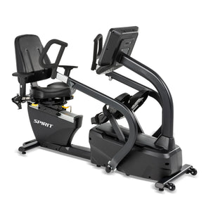 The Spirit Fitness CRS800S Recumbent Seated Stepper is a black exercise bike with a seat, backrest, side handles, and digital display. The Spirit Fitness brand name appears on the side of the stepper.