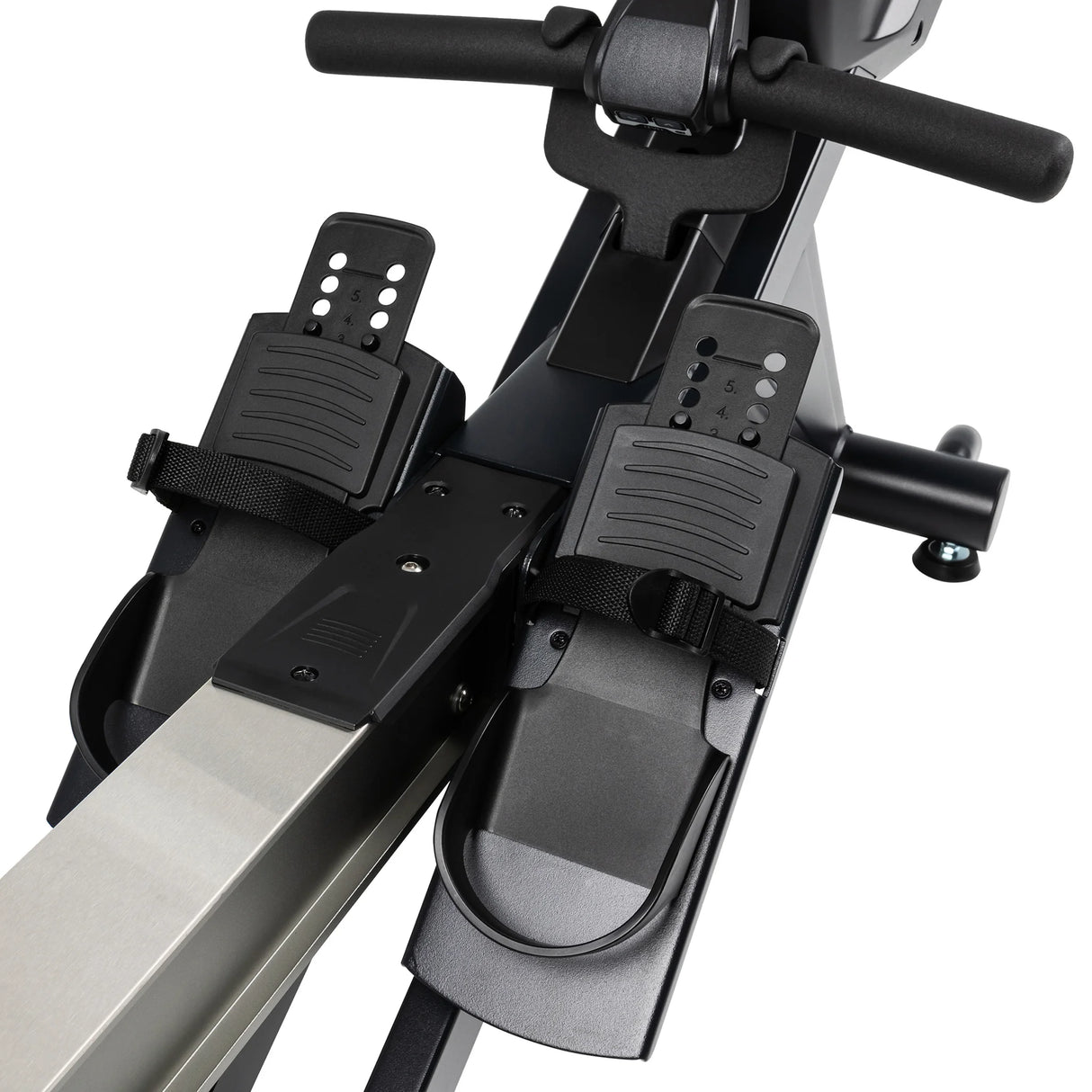 Close-up of the foot pedals and straps on the Spirit Fitness CRW800 Rower, with the handlebars above and part of the frame visible.