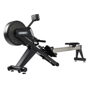 The Spirit Fitness CRW800 Rower by Spirit Fitness features a black and silver design with a large flywheel, footrests, and sliding seat for indoor workouts, shown on a white background.