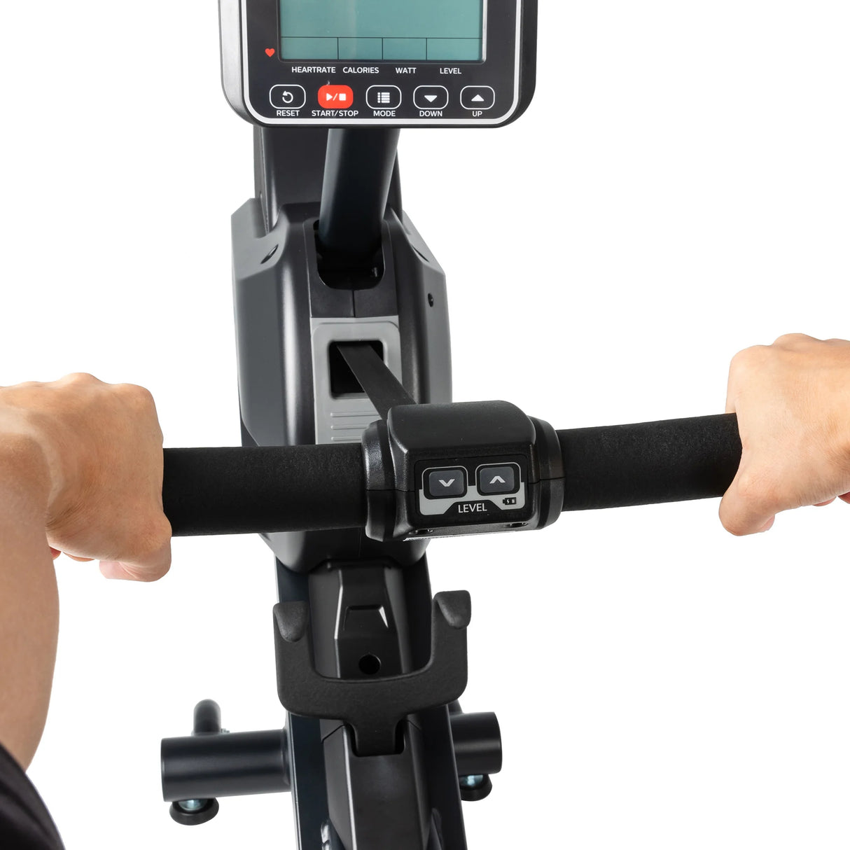 Close-up view of a person’s hands gripping the handlebars of the Spirit Fitness CRW800 Rower, with its central display screen and control buttons visible.
