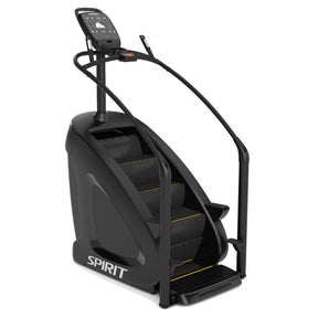 The Spirit Fitness CSC900 Stair Climber by Spirit Fitness is a black machine featuring handrails, a digital display, and four rotating steps with yellow accents.