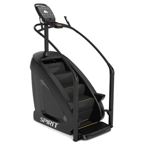 The Spirit Fitness CSC900 Stair Climber by Spirit Fitness is a black machine featuring handrails, a digital display, and four rotating steps with yellow accents.