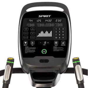 Close-up of the Spirit Fitness CSC900 Stair Climber control panel showing digital display for speed, time, distance, heart rate, various buttons for settings and programs, along with handrails and heart rate sensors.
