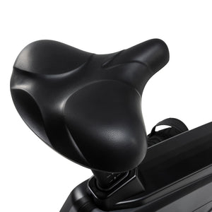 Close-up of the wide, contoured saddle on the Spirit Fitness CU1000ENT Upright Bike, showing the cushioned seat padding and stitching detail.